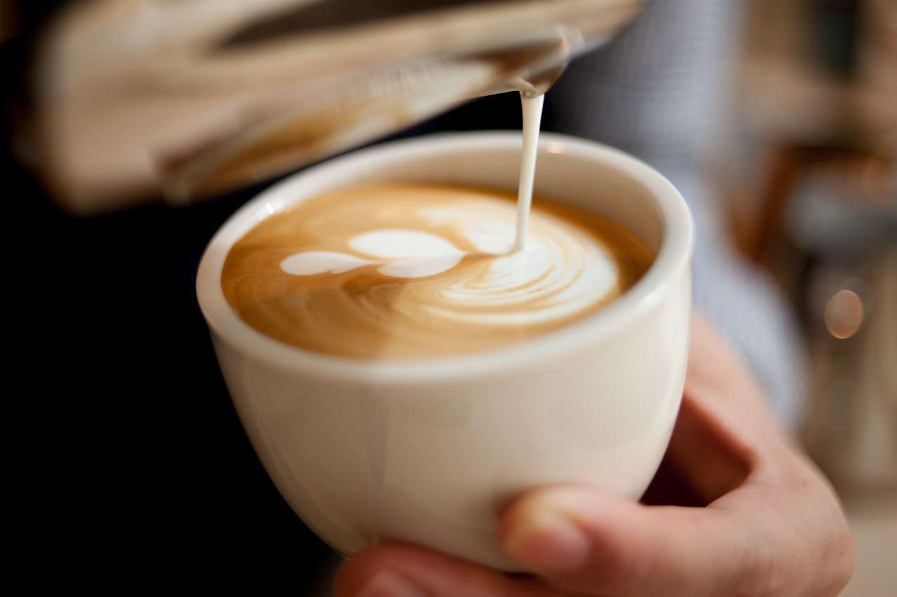 Milk being poured into a coffee cup.