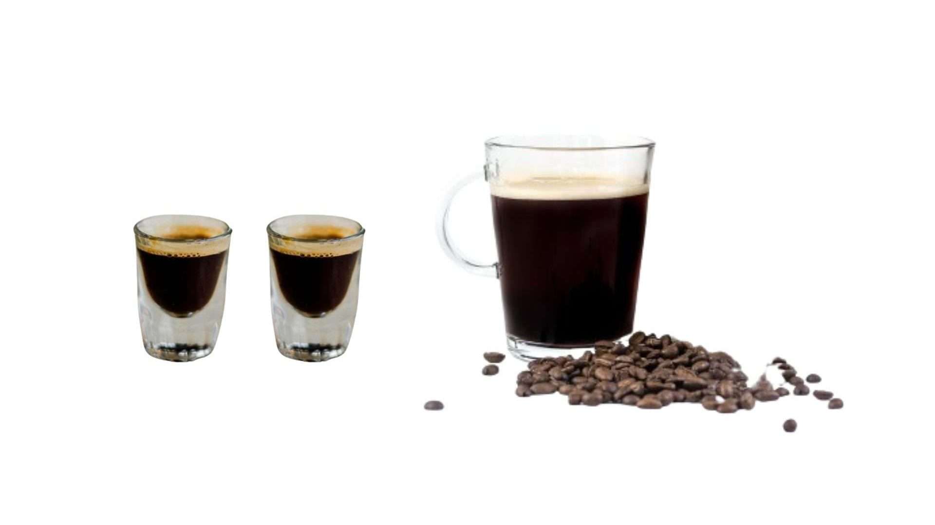 "A clear glass mug filled with Black eye coffee next to a  2 shot of espresso and a scattered pile of whole coffee beans on a white background