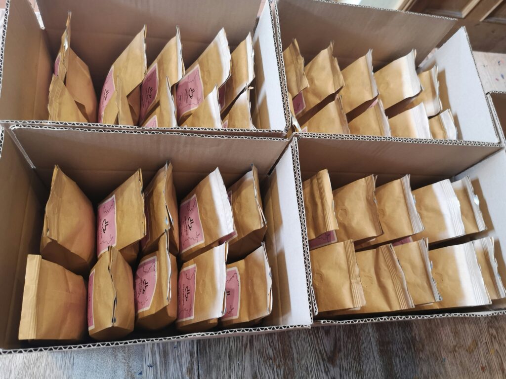 Boxes filled with sealed packages of coffee beans.