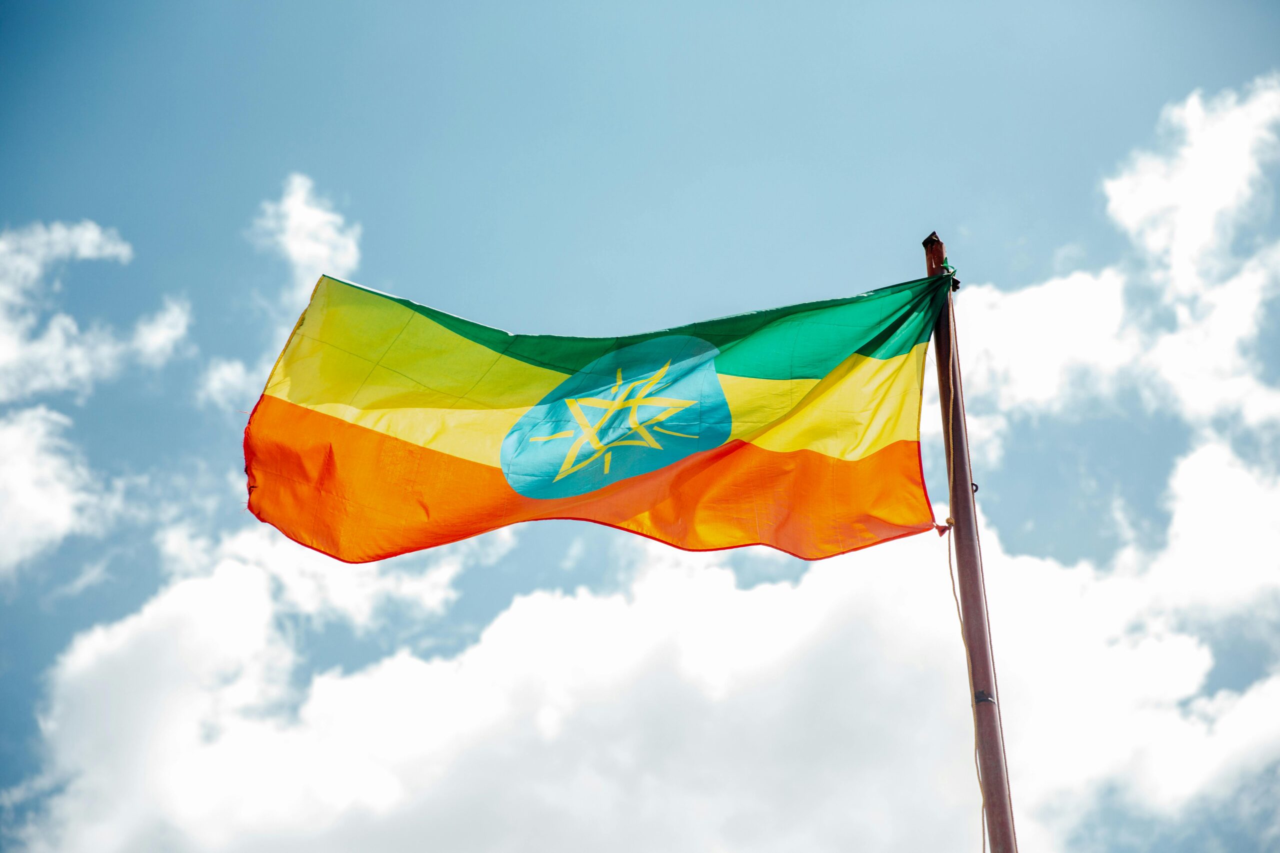 a Ethiopian flag on a pole